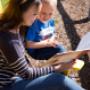 Frau und Kind auf Sonnenstuhl mit Buch Frau und Kind auf Sonnenstuhl mit Buch