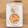 Portugiesische Tapas zum Verlieben: Gambas in Knoblauchöl mit frischem Brot. Besuchen Sie unsere Petiscos Bar direkt beim Naschmarkt.