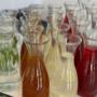 Hausgemachte Limonaden und Säfte in Glasflaschen am Buffet – erfrischende Begleitung zum Mittagessen in der Vitmins Mensa/Cafe.