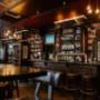 Gemütliches Pub Ambiente im Trinity Pub Vienna in Wien – uriges Irish Pub und Whiskey Bar mit stilvollem Holz-Tresen und Barhockern.